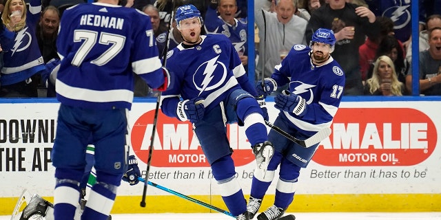 Tampa Bay Lightning center Steven Stamkos (91) celebrates his goal against the Vancouver Canucks with defenseman Victor Hedman (77) and left wing Alex Killorn (17) during the first period of an NHL hockey game Thursday, Jan. 13, 2022, in Tampa, Fla.