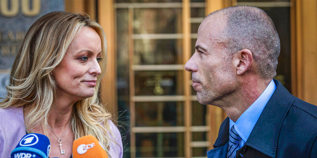 Adult film actress Stormy Daniels, left, stands with her former lawyer Michael Avenatti during a news conference.