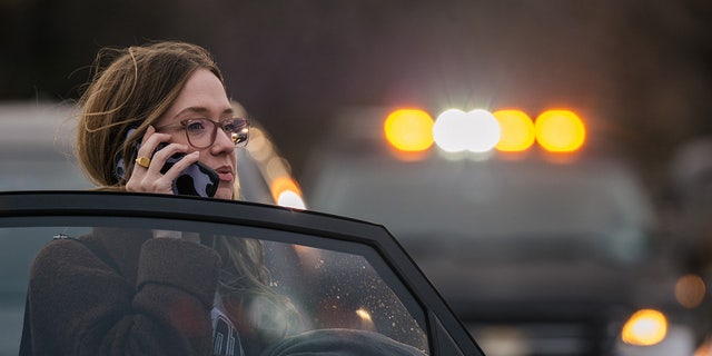 A woman speaks on the phone near the Congregation Beth Israel synagogue on Jan. 15, 2022 in Colleyville, Texas. Police responded to a hostage situation after reports of a man with a gun was holding people captive at the synagogue.