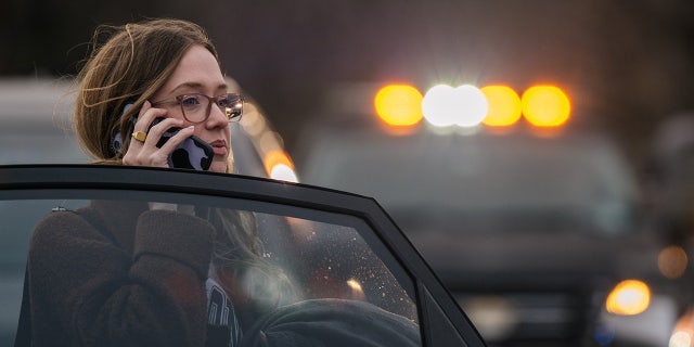 A woman speaks on the phone near the Congregation Beth Israel synagogue on Jan. 15, 2022 in Colleyville, Texas. Police responded to a hostage situation after reports of a man with a gun was holding people captive at the synagogue.