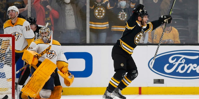Boston Bruins' Taylor Hall celebrates his game winning goal in overtime on Nashville Predators goaltender Juuse Saros during an NHL hockey game Saturday, Jan. 15, 2022, in Boston. Hall scored off a rebound of David Pastrnak’s shot 1:41 into overtime, lifting the red-hot Boston Bruins to a 4-3 win over Nashville.