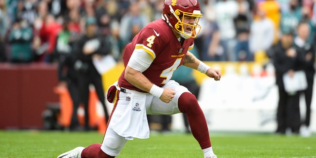 Washington Football Team quarterback Taylor Heinicke reacts after scoring a touchdown against the Philadelphia Eagles Sunday, Jan. 2, 2022, in Landover, Maryland.