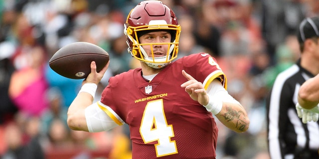 Washington Football Team quarterback Taylor Heinicke (4) passing the ball against the Philadelphia Eagles during the first half of an NFL football game, Sunday, Jan. 2, 2022, in Landover, Maryland.