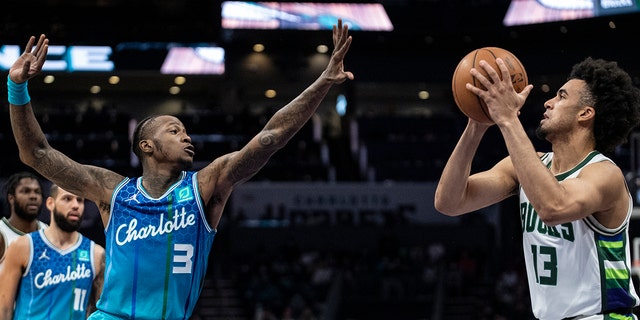 Charlotte Hornets guard Terry Rozier (3) defends Milwaukee Bucks forward Jordan Nwora (13) during the first half of an NBA basketball game, Sabato, Jan. 8, 2022, a Charlotte, N.C.
