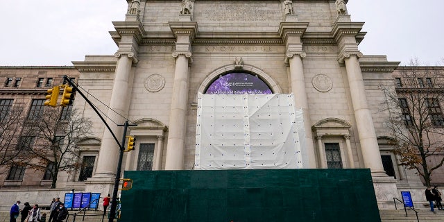 A wall scaffolding and white tarp surround what is left of the controversial equestrian statue of President Theodore Roosevelt, at the American Museum of Natural History this week in New York City. A crew removed a portion of the statue overnight.