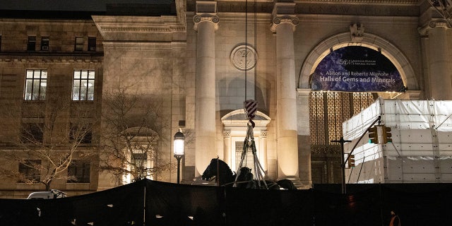 Workers remove part of a statue of Theodore Roosevelt that has stood outside the entrance to the American Museum of Natural History in New York City since 1940, which the museum proposed to remove following objections from some that it was a symbol of colonialism, Jan. 20, 2022.
