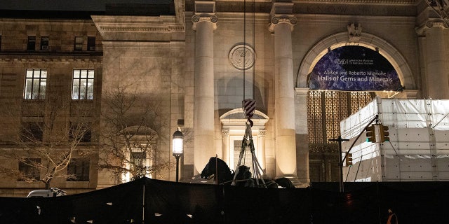 Workers remove part of a statue of Theodore Roosevelt that has stood outside the entrance to the American Museum of Natural History in New York City since 1940, which the museum proposed to remove following objections from some that it was a symbol of colonialism, Jan. 20, 2022. 