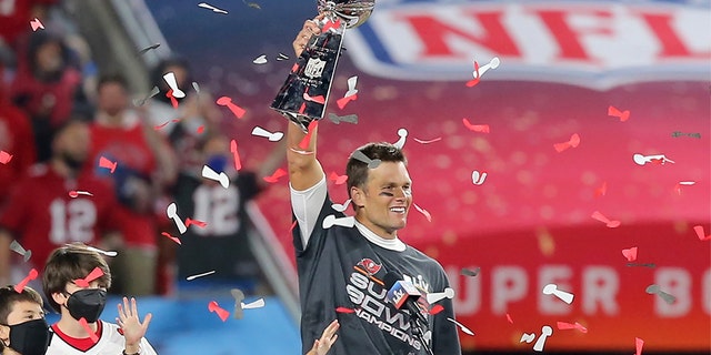 Super Bowl MVP Tom Brady (12) of the Buccaneers holds the Lombardi Trophy surrounded by his kids Benjamin Brady, John Edward Thomas Moynahan and Vivian Lake Brady after the Super Bowl LV game between the Kansas City Chiefs and the Tampa Bay Buccaneers Feb. 7, 2021 at Raymond James Stadium, in Tampa, Fla.