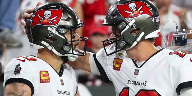 Buccaneers wide receiver Mike Evans is congratulated by Tom Brady after Evans caught a touchdown pass against the Carolina Panthers on Jan. 9, 2022, at Raymond James Stadium in Tampa, Florida.