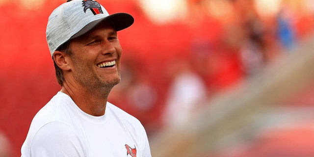 Tom Brady #12 of the Tampa Bay Buccaneers looks on during a preseason game against the Tennessee Titans at Raymond James Stadium on Aug. 21, 2021 a Tampa, Florida.