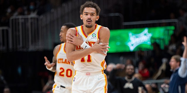 Atlanta Hawks guard Trae Young (11) reacts after making a 3-pointer during the second half of the team's NBA basketball game against the Minnesota Timberwolves on Wednesday, Jan. 19, 2022, in Atlanta.