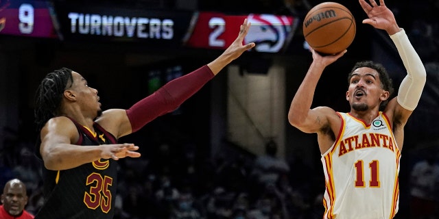 Atlanta Hawks' Trae Young (11) shoots against Cleveland Cavaliers' Isaac Okoro (35) during the second half of an NBA basketball game Friday, Dec. 31, 2021, in Cleveland.