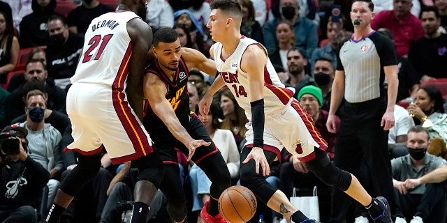 Miami Heat guard Tyler Herro (14) drives to the basket as Atlanta Hawks guard Timothe Luwawu-Cabarrot, left, defends during the first half of an NBA basketball game, Friday, Jan. 14, 2022, in Miami.