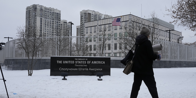 A woman walks past the U.S. Embassy in Kyiv, Ukraine, on Monday.