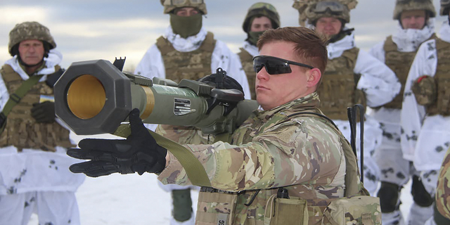A U.S. instructor trains Ukrainian soldiers for the use of M141 Bunker Defeat Munition (SMAW-D) missiles at the Yavoriv military training ground, close to Lviv, western Ukraine, on Sunday. (AP/Ukrainian Defense Ministry Press Service)