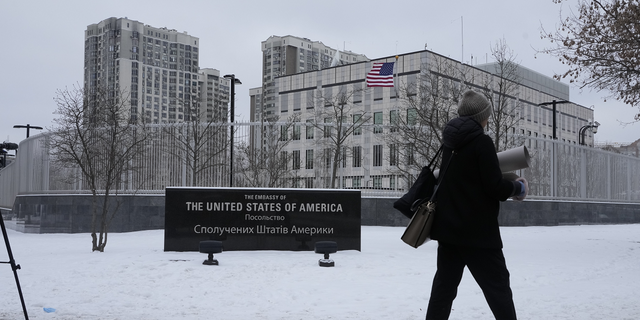 A woman walks past the U.S. Embassy in Kyiv, Ukraine, on Monday.