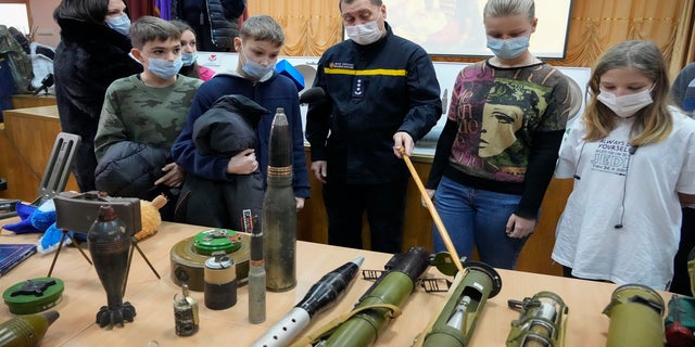 A police officer shows explosives to schoolchildren during a police-organized civilian safety lesson in a city school in Kyiv, Ukraine,  on Thursday. 