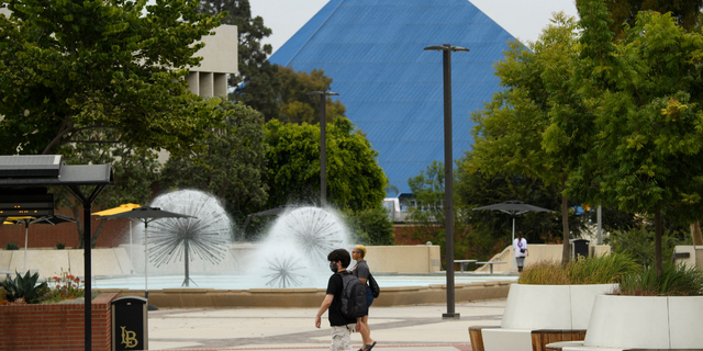 People walk on the California State University Long Beach (CSULB) campus before the return of students for Fall classes on August 11, 2021, in Long Beach, California.