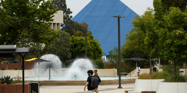 People walk on the California State University Long Beach (CSULB) campus before the return of students for Fall classes on August 11, 2021, in Long Beach, California.