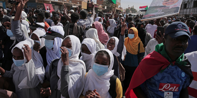 People chant slogans during a protest to denounce the October 2021 military coup, in Khartoum, Sudan, Sunday, Jan. 2, 2022. Sudanese security forces fired tear gas Sunday to disperse protesters as thousands rallied against military rule, medics said. (AP Photo/Marwan Ali)