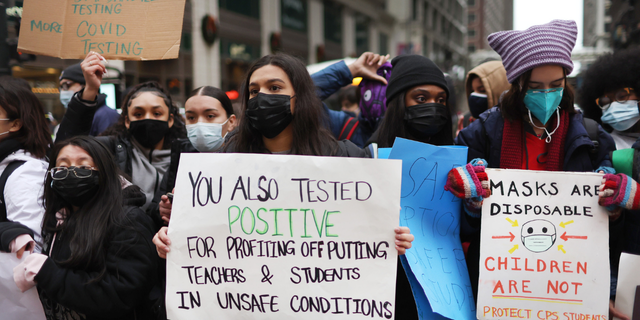 Public school students protest outside the Chicago Public Schools headquarters after walking out of their classrooms on Jan. 14, 2022, in Chicago.