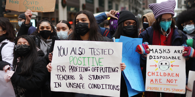 CHICAGO, ILLINOIS - JANUARY 14: Public school students protest outside of the Chicago Public Schools headquarters after walking out of their classrooms on January 14, 2022 in Chicago, Illinois. The students walked out of class to demand a voice in the ongoing battle between the school district and the teacher's union over COVID-19 safety measures. (Photo by Scott Olson/Getty Images)