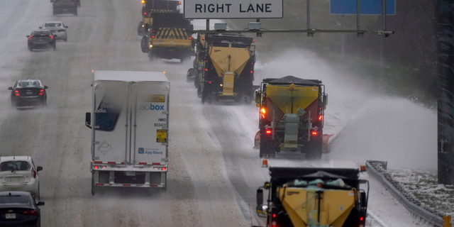 Vehicles navigate hazardous driving conditions along Interstate 85/40 as a winter storm moves through the area in Mebane, N.C., Sunday, Jan. 16, 2022. 