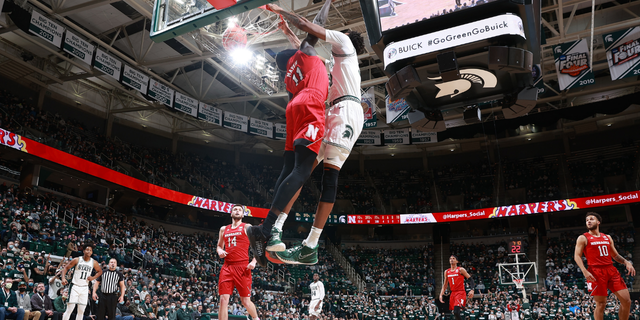 Marcus Bingham Jr. #30 of the Michigan State Spartans dunks the ball over Lat Mayen #11 of the Nebraska Cornhuskers in the first half at Breslin Center on January 5, 2022 in East Lansing, Michigan.