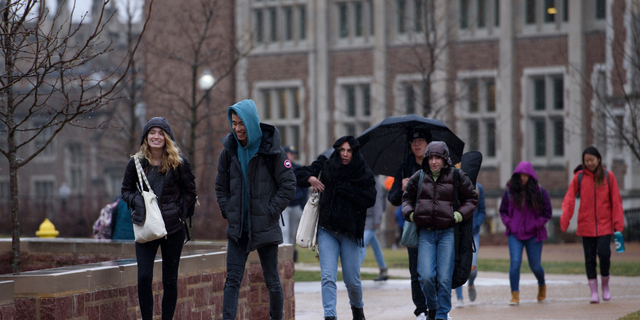 Students walk through campus at Washington University in St. Louis, MO on Wednesday, February 12, 2020.