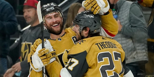 Vegas Golden Knights defenseman Alex Pietrangelo, links, celebrates after defenseman Shea Theodore, reg, scored the game winning goal against the Montreal Canadiens during overtime of an NHL hockey game Thursday, Jan.. 20, 2022, in Las Vegas.