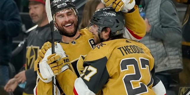 Vegas Golden Knights defenseman Alex Pietrangelo, links, celebrates after defenseman Shea Theodore, reg, scored the game winning goal against the Montreal Canadiens during overtime of an NHL hockey game Thursday, Jan.. 20, 2022, in Las Vegas.