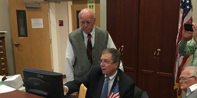 New Hampshire Secretary of State Bill Gardner and deputy Secretary of State Dave Scanlan review the ballot count during an election recount, in Concord, New Hampshire in 2018.