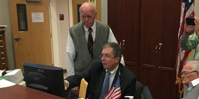 New Hampshire Secretary of State Bill Gardner and deputy Secretary of State Dave Scanlan review the ballot count during an election recount, in Concord, New Hampshire in 2018.