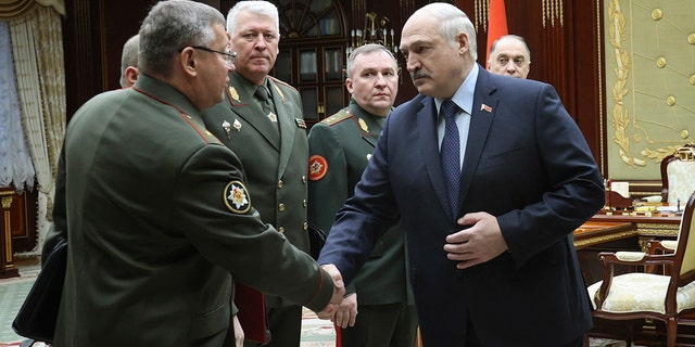 Belarusian President Alexander Lukashenko, second right, greets military top officials during their meeting in Minsk, Belarus, Monday, Jan.17, 2022. 