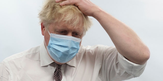 Britain's Prime Minister Boris Johnson gestures during a visit to Finchley Memorial Hospital, in North London, Tuesday, Jan. 18, 2022.