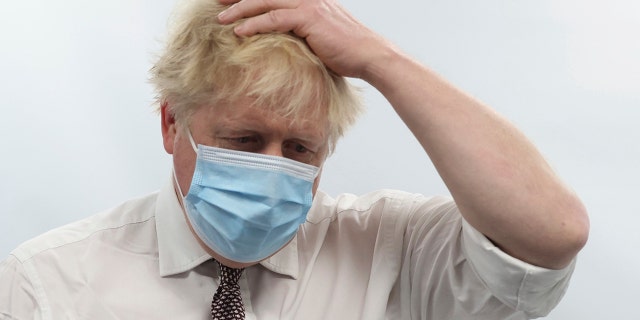Britain's Prime Minister Boris Johnson gestures during a visit to Finchley Memorial Hospital, in North London, Tuesday, Jan. 18, 2022.