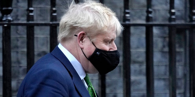 Britain's Prime Minister Boris Johnson leaves 10 Downing Street to attend the weekly session of Prime Minister's Questions in Parliament in London, Wednesday, Jan. 19, 2022.
