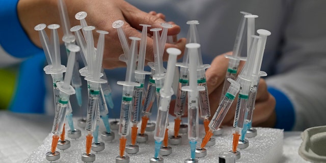 A nurse prepares vaccines in the Wizink Center, currently used for COVID-19 vaccinations, in Madrid, Dec. 1, 2021.