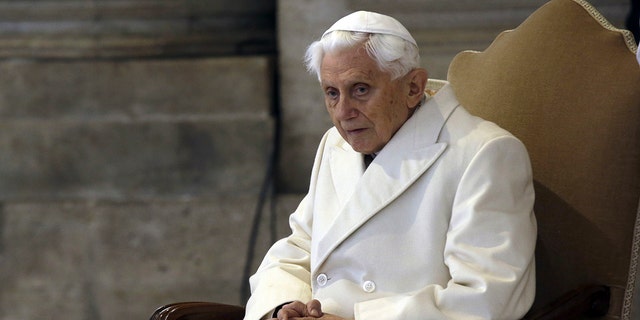 Pope Emeritus Benedict XVI sits in St. Peter's Basilica as he attends the ceremony marking the start of the Holy Year, at the Vatican, Dec. 8, 2015.