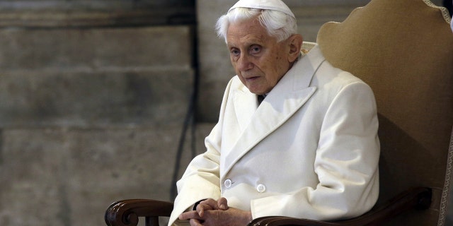 Pope Emeritus Benedict XVI sits in St. Peter's Basilica as he attends the ceremony marking the start of the Holy Year, at the Vatican, Dec. 8, 2015.