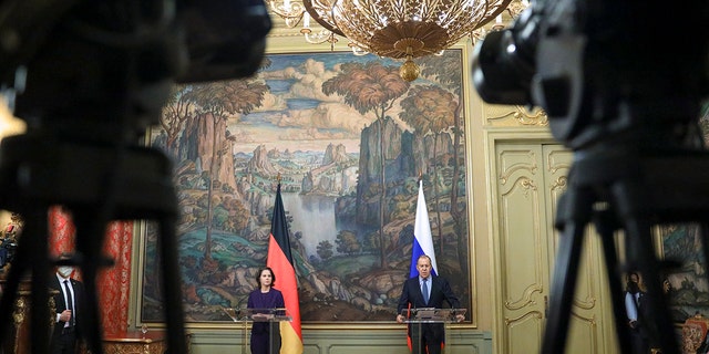 In this handout photo released by Russian Foreign Ministry Press Service, Russian Foreign Minister Sergey Lavrov and German Foreign Minister Annalena Baerbock attend a joint news conference following their talks in Moscow, Russia, Tuesday, Jan. 18, 2022. 