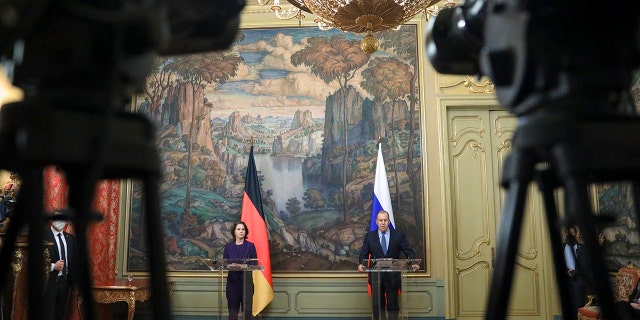 In this handout photo released by Russian Foreign Ministry Press Service, Russian Foreign Minister Sergey Lavrov and German Foreign Minister Annalena Baerbock attend a joint news conference following their talks in Moscow, Russia, Tuesday, Jan. 18, 2022.