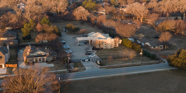 An aerial view of police standing in front of the Congregation Beth Israel synagogue, Sunday, Jan. 16, 2022, in Colleyville, Texas.