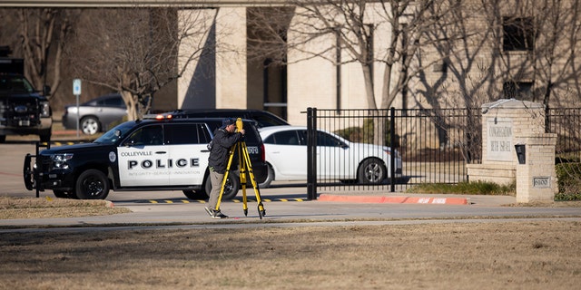 Law enforcement process the scene in front of the Congregation Beth Israel synagogue, Sunday, Jan. 16, 2022, in Colleyville, Texas.