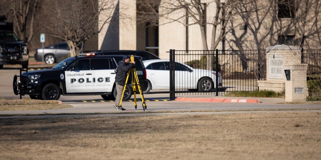 Law enforcement process the scene in front of the Congregation Beth Israel synagogue, Sunday, Jan. 16, 2022, in Colleyville, Texas.