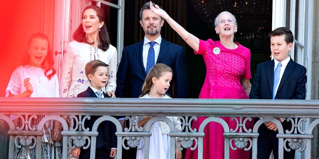 Queen Margrethe of Denmark, second right, and her son Crown Prince Frederik, center, stand on the balcony at Amalienborg Castle in Copenhagen on May 26, 2018, to celebrate the 50th birthday of the Crown Prince.