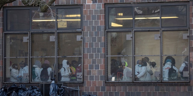 Cleaning and recovery crews work in the apartment building in the Bronx on Monday, Jan.. 10, 2022, In New York.