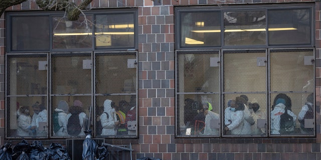 Cleaning and recovery crews work in the apartment building in the Bronx on Monday, Jan. 10, 2022, in New York. 