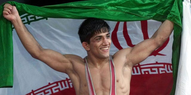 Alireza Dabir of Iran celebrates gold medal win for 58-kilogram Freestyle Wrestling at Sydney 2000 Summer Olympic Games, photo on black