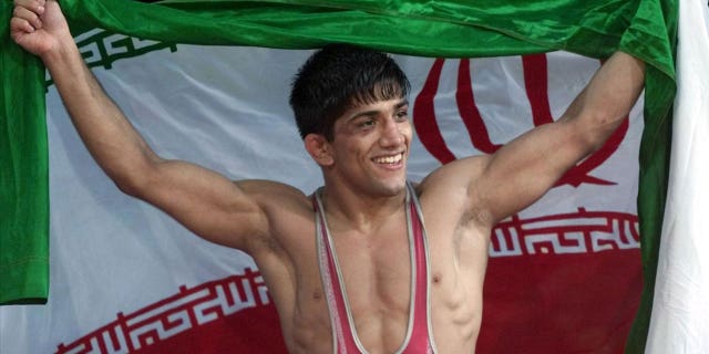 Alireza Dabir of Iran celebrates gold medal win for 58-kilogram Freestyle Wrestling at Sydney 2000 Summer Olympic Games, photo on black